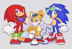 Size: 2048x1400 | Tagged: safe, artist:mossan315, knuckles the echidna, miles "tails" prower, sonic the hedgehog, echidna, fox, hedgehog, blushing, clenched fists, goggles, goggles around neck, goggles on head, grey background, grin, looking at viewer, mouth open, simple background, smile, sonic riders, standing, team sonic, trio