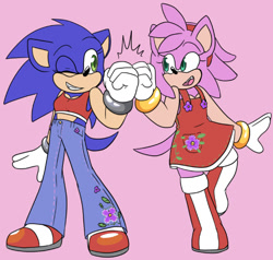 Size: 540x515 | Tagged: safe, artist:sonicaspeed123, amy rose, sonic the hedgehog, hedgehog, au:girls girls girls (sonicaspeed123), boots, clenched teeth, crop top, dress, duo, female, fistbump, genderqueer, looking at each other, mouth open, pants, pink background, shoes, simple background, standing, standing on one leg, trans female, trans girl sonic, transgender, wink