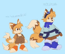 Size: 2047x1692 | Tagged: safe, artist:sonicattos, miles "tails" prower, fox, belt, blue background, blushing, character name, classic tails, clothes, coat, cute, duality, ear fluff, english text, goggles, looking at viewer, modern tails, overalls, redesign, scarf, simple background, smile, solo, standing, tailabetes