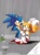 Size: 608x828 | Tagged: artist needed, source needed, safe, miles "tails" prower, sonic the hedgehog, abstract background, blushing, blushing ears, cupid arrow, duo, flower, gay, heart, holding arm, looking at each other, outdoors, puddle, rain, shipping, signature, smile, sonic x tails, standing