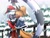 Size: 2048x1546 | Tagged: safe, artist:theopossumdude, tangle the lemur, whisper the wolf, lemur, wolf, 2024, abstract background, blushing, christmas, christmas hat, christmas outfit, daytime, duo, eyes closed, female, holding each other, idw sonic the hedgehog, lesbian, looking at them, mistletoe, outdoors, shipping, smile, snow, snowing, standing, tail hold, tangle x whisper, tree, wagging tail