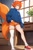 Size: 512x768 | Tagged: safe, ai art, miles "tails" prower, human, asymmetrical legwear, daytime, humanized, indoors, male, orange hair, plant, plant pot, shoes, shorts, single sock, single thighhigh, sweater, window
