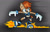 Size: 1024x663 | Tagged: safe, artist:bohemianlizardking, sally acorn, chipmunk, hybrid, squirrel, 2018, female, fire, flame, looking offscreen, rocket shoes, sally's ringblader outfit, solo, stopping