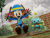Size: 1920x1463 | Tagged: safe, artist:spinoskingdom875, cheese (chao), cream the rabbit, chao, rabbit, 3d, agender, alternate outfit, boots, brick wall, bush, clouds, coat, duo, female, hat, jumping, looking down, mouth open, mud, open smile, outdoors, raincoat, smile, watermark